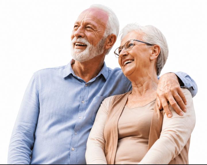 Happy senior couple smiling outdoors — enjoying life with support from SeniorLiving Guide
